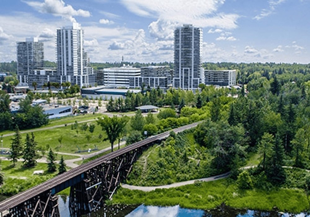 Urban skyline with trees and a bridge